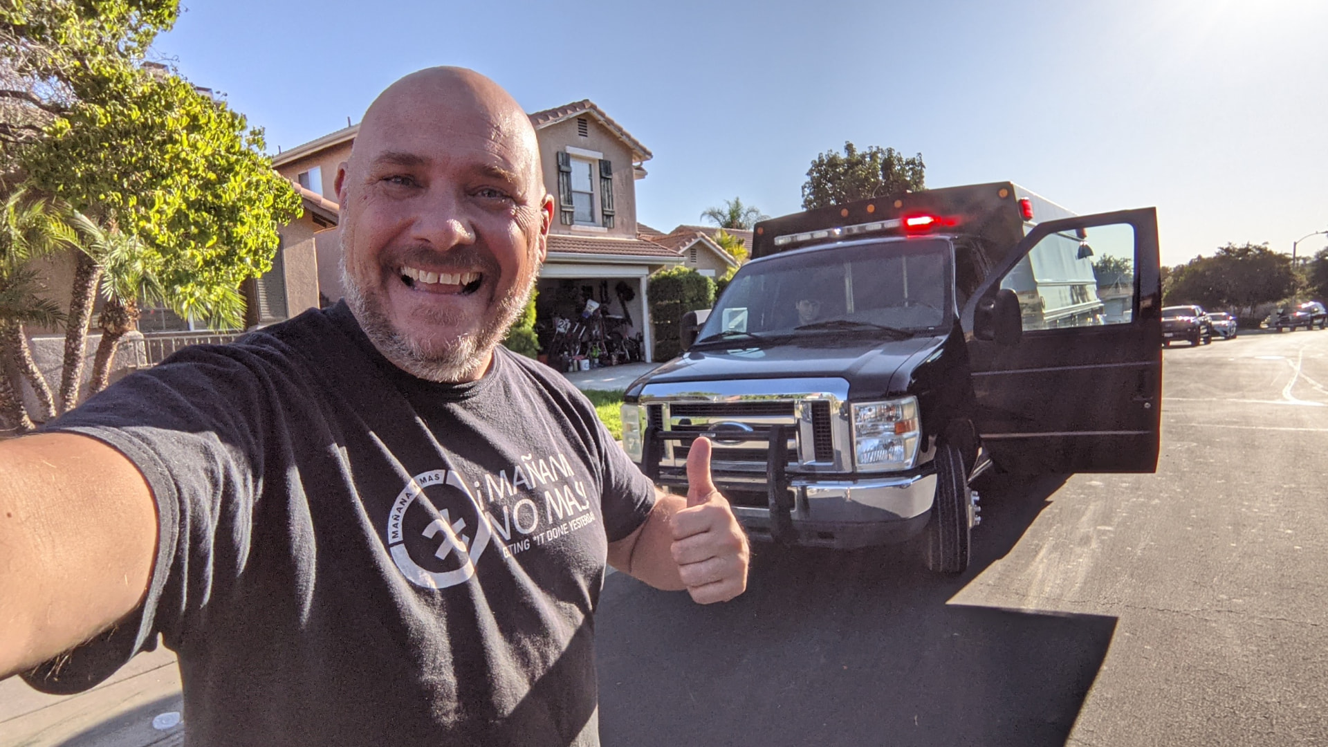 Kurt Von Ahnen giving a thumbs up next to a work truck